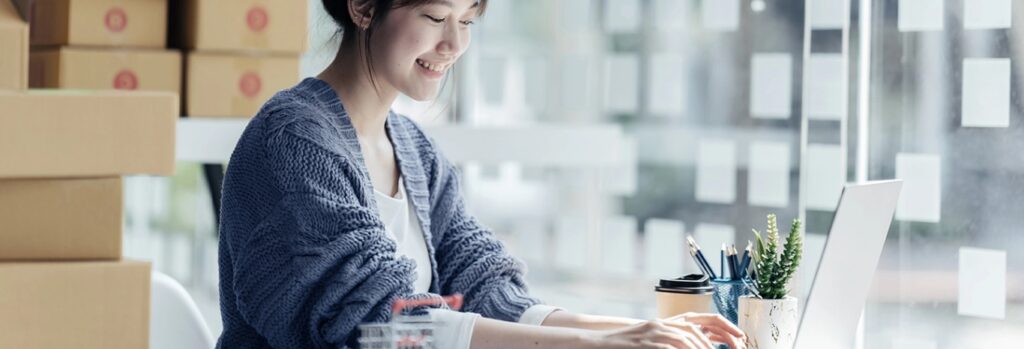 smiling woman on laptop full width image